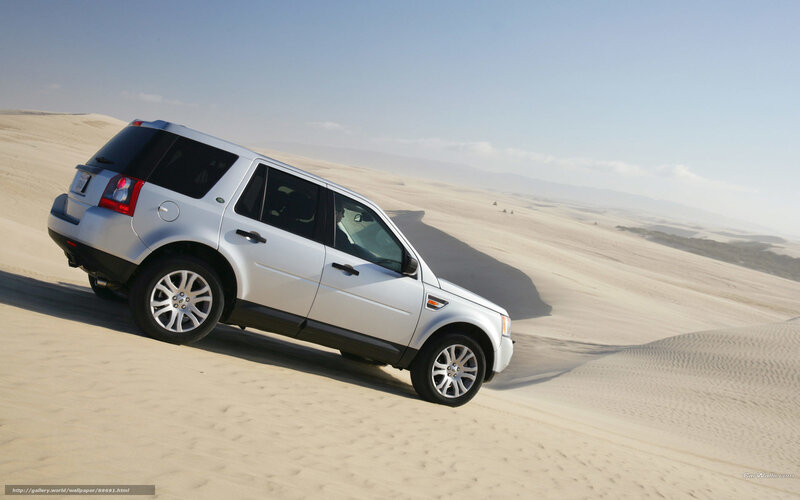 silver suv on sand dune