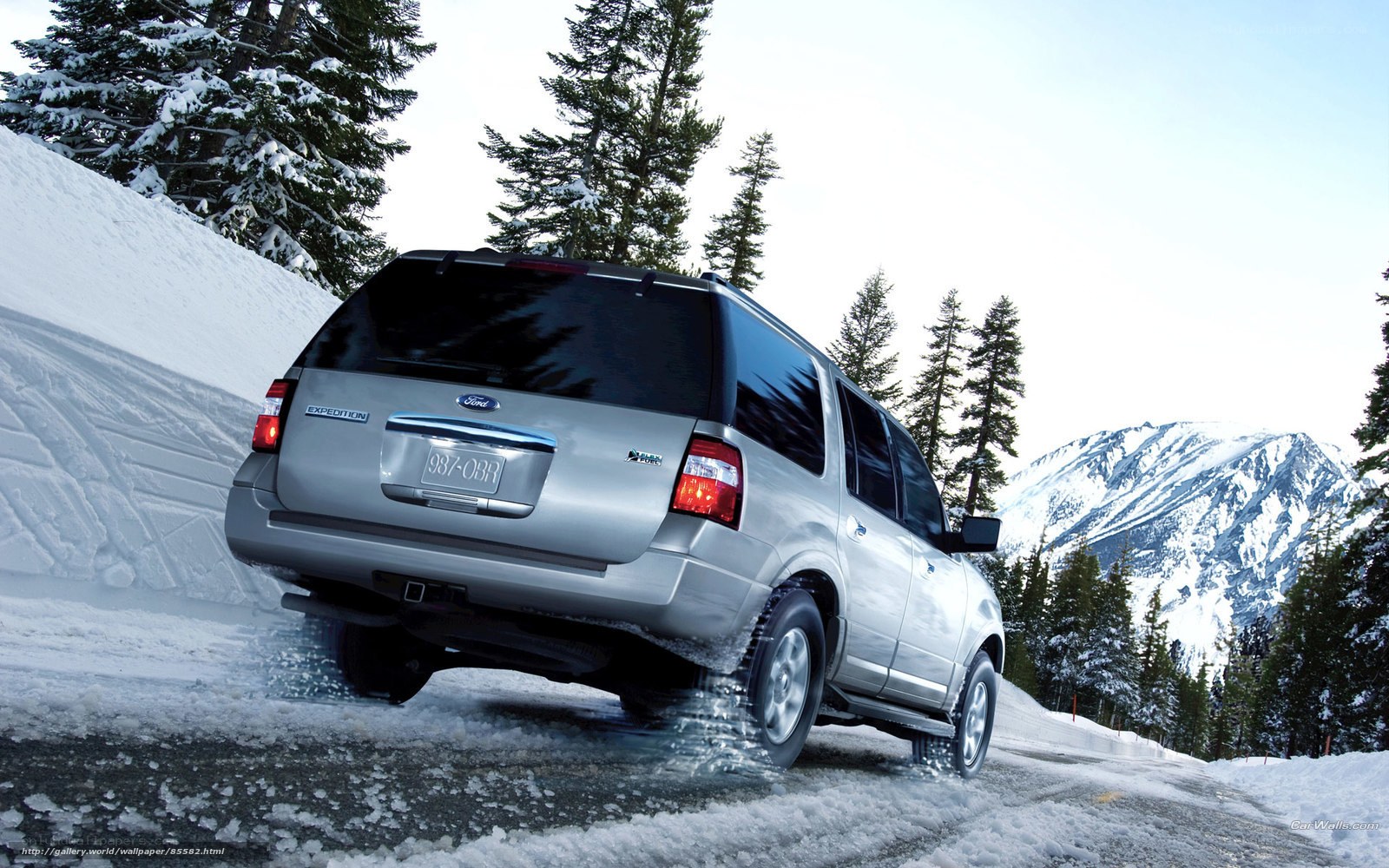 Silver SUV on snowy mountain road