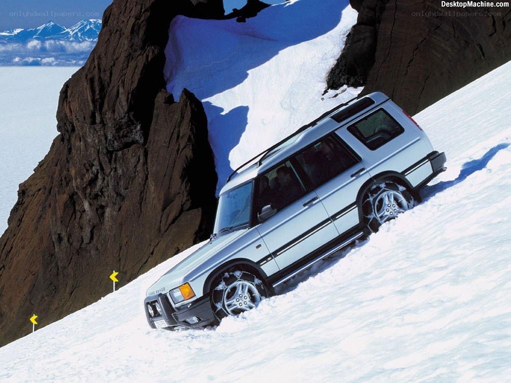 silver suv on snowy slope