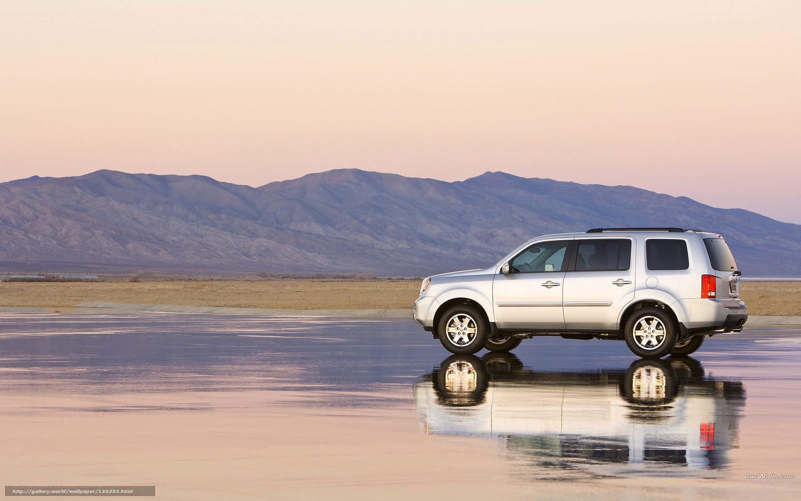 Silver SUV on wet pavement