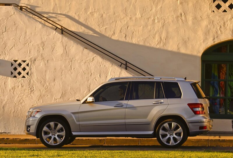Silver SUV parked by wall
