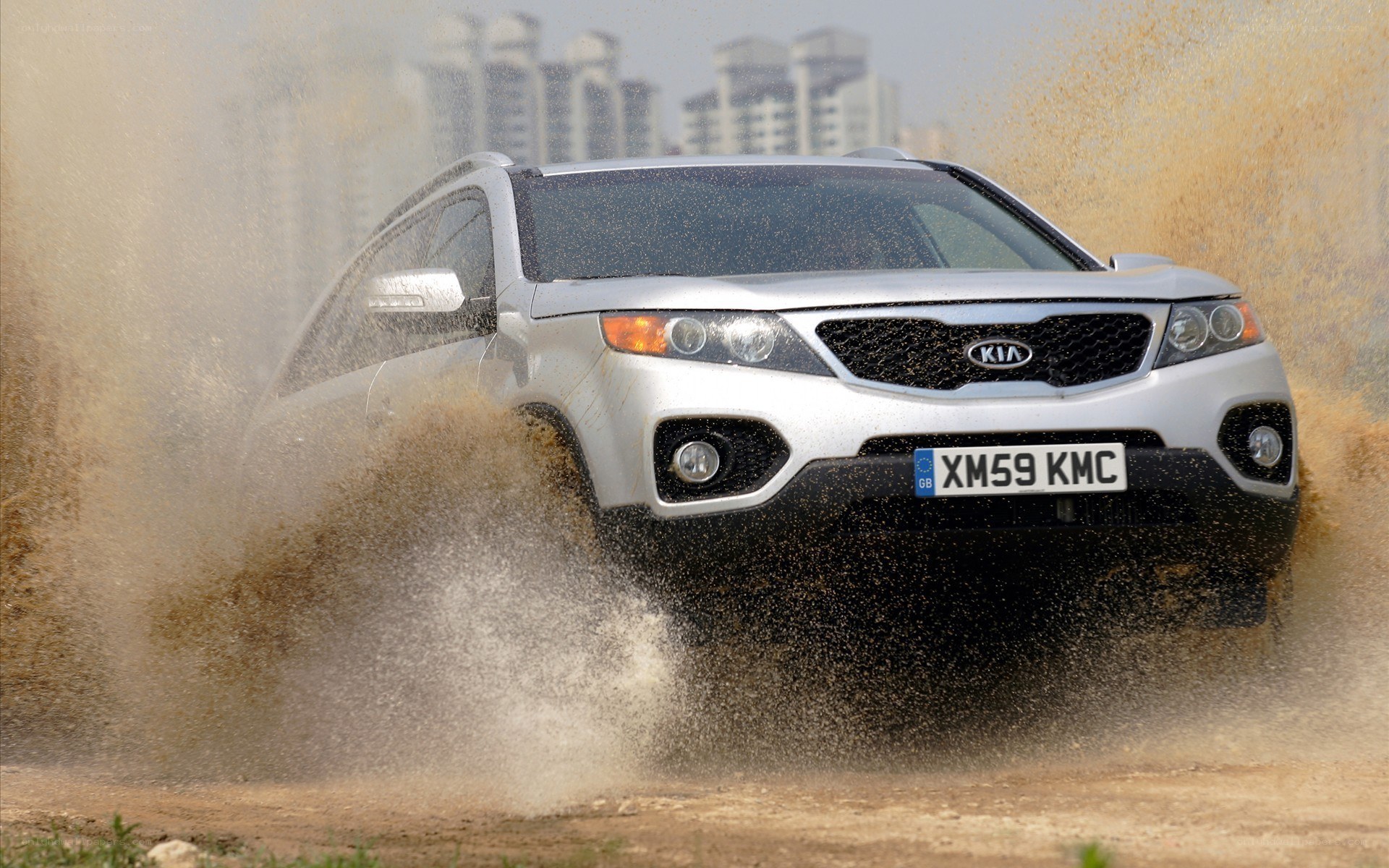 Silver SUV splashing mud