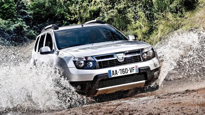 Silver SUV splashing through mud