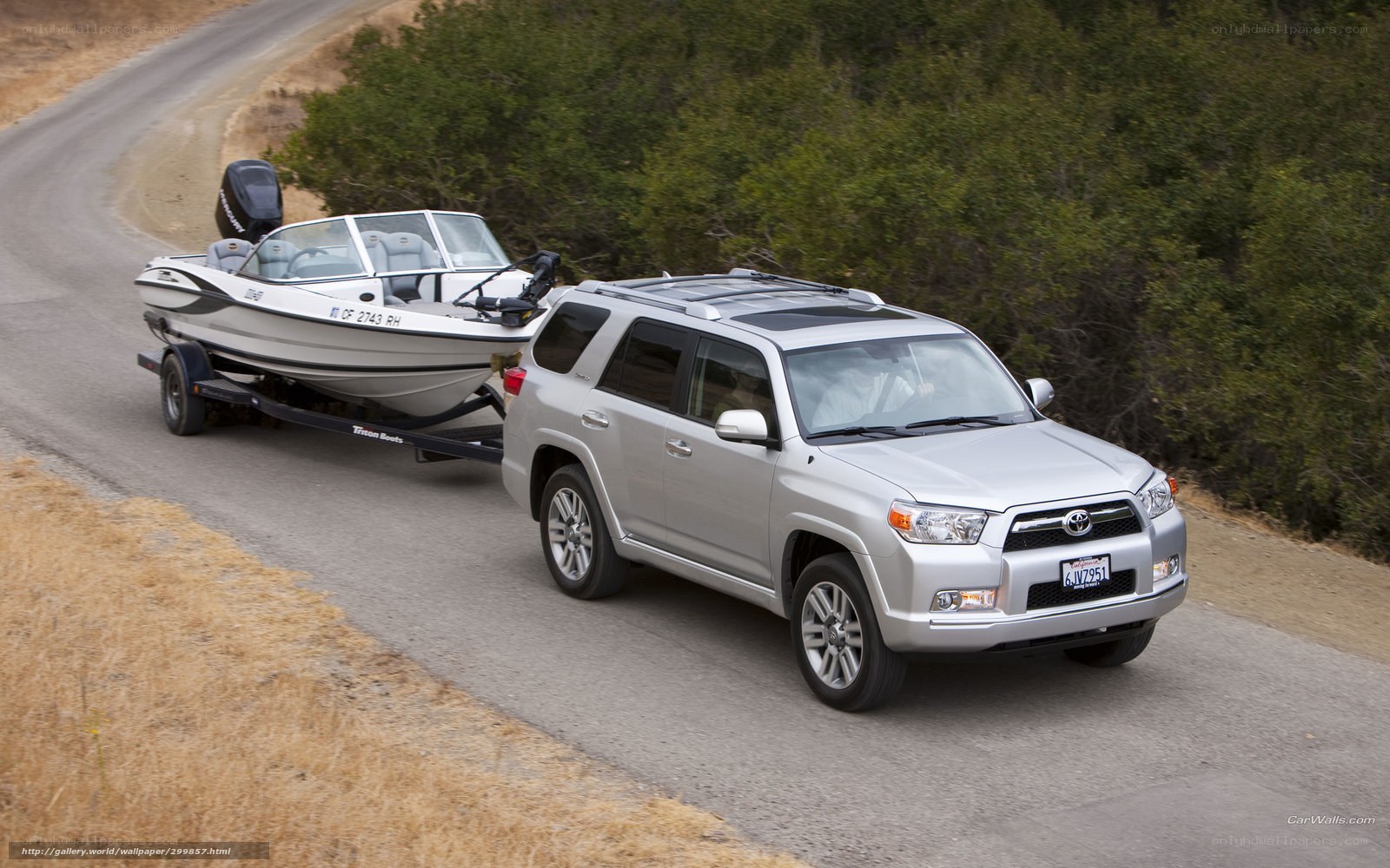 silver suv towing boat