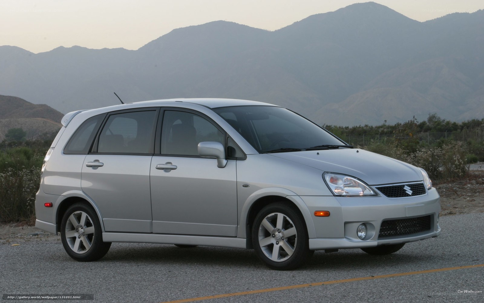 silver suzuki aerio parked on road