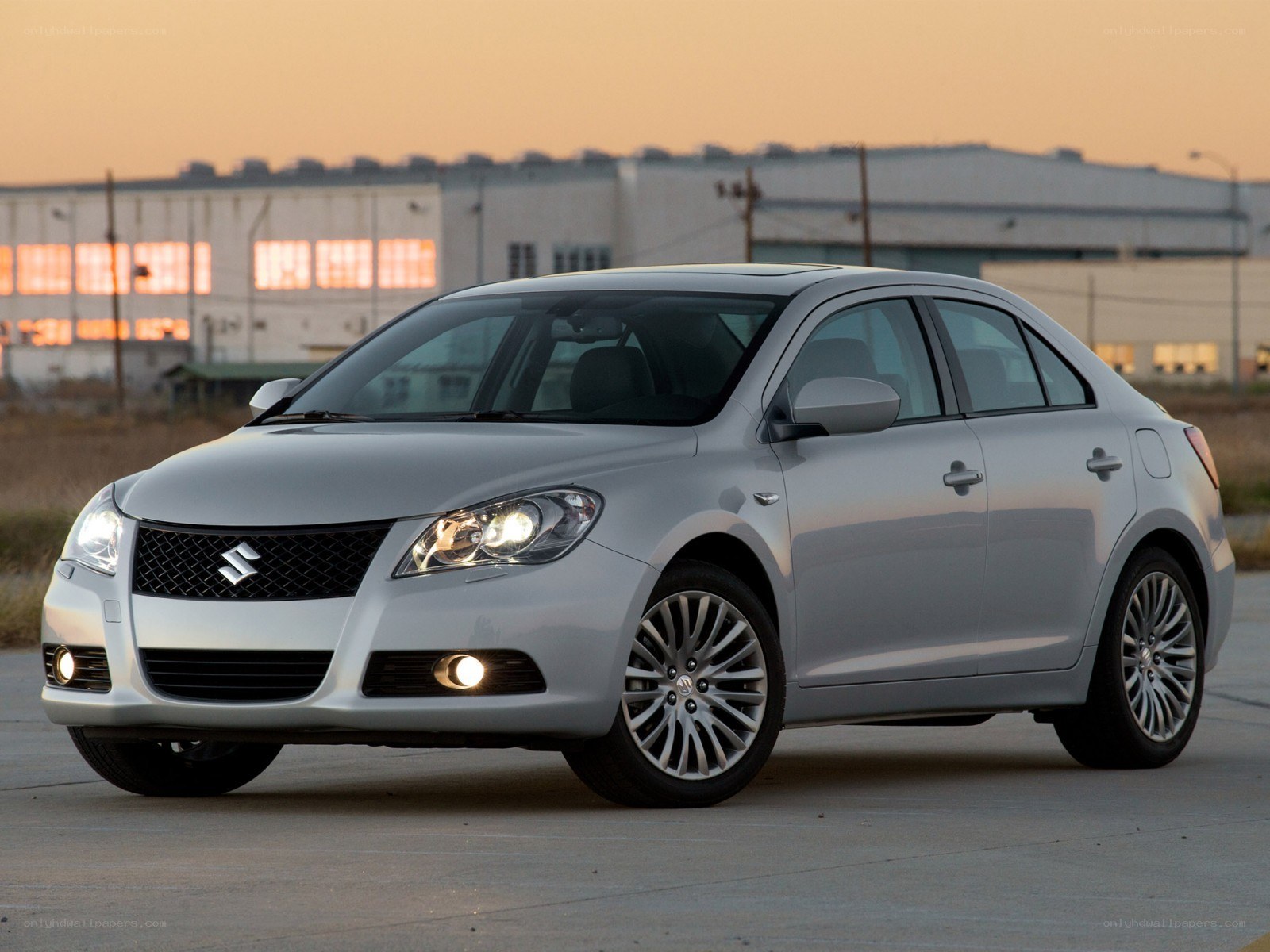 silver suzuki sedan at dusk