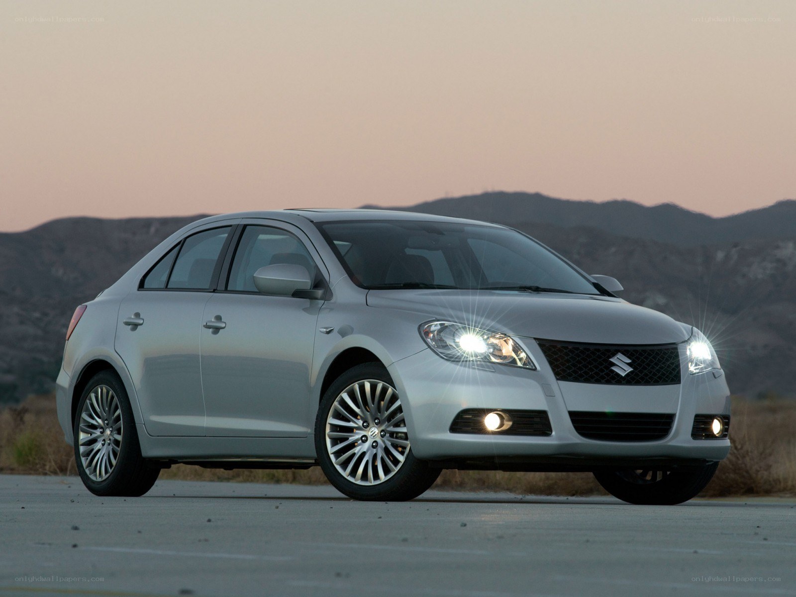 silver suzuki sedan at dusk