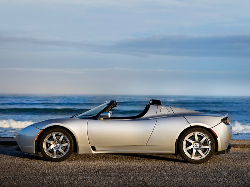 Silver Tesla Roadster by the ocean