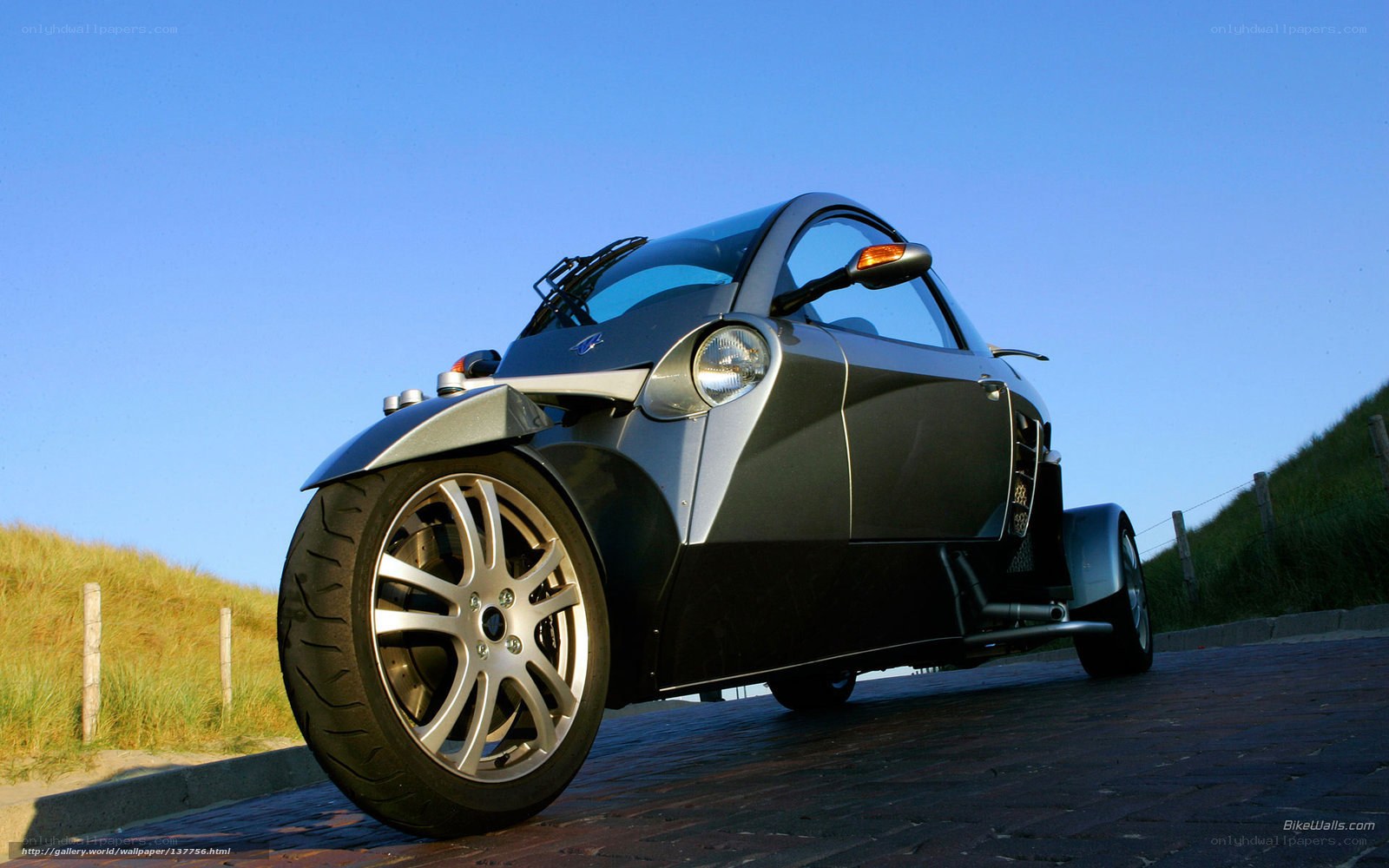 Silver three-wheeled car on a path