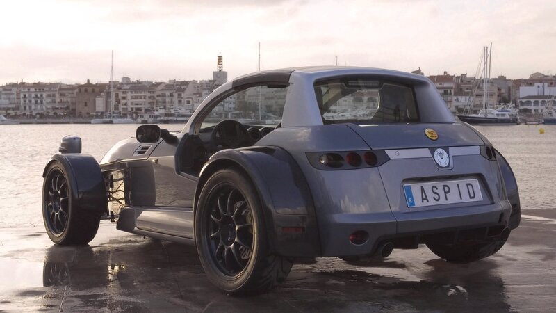 silver three-wheeled sports car