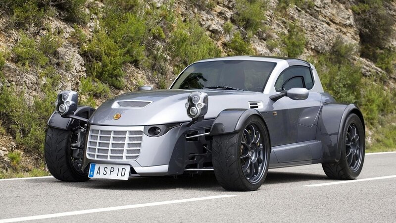 silver three-wheeled sports car