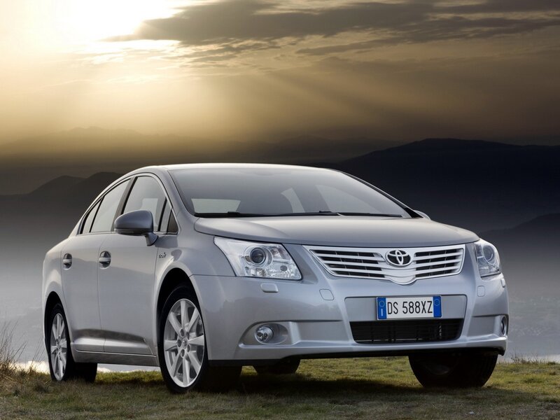 silver toyota avensis at sunset