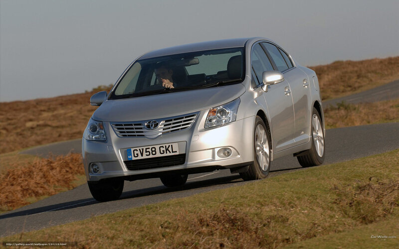 silver toyota avensis driving