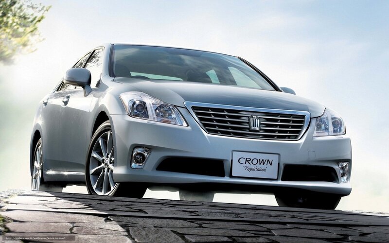 Silver Toyota Crown on cobblestone