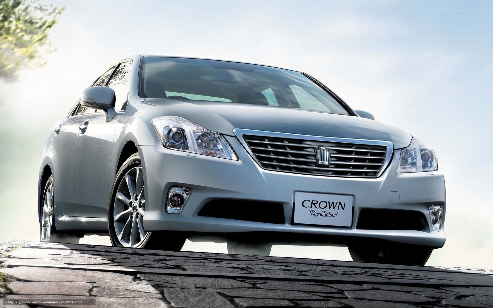 Silver Toyota Crown on cobblestone