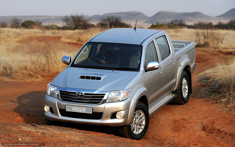 Silver Toyota Hilux on dirt road