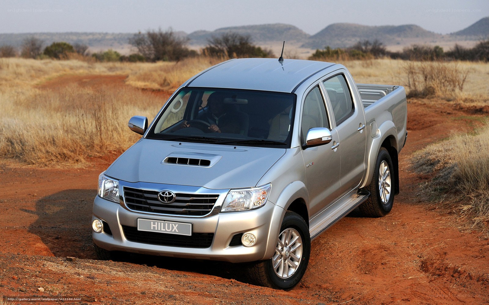 Silver Toyota Hilux on dirt road