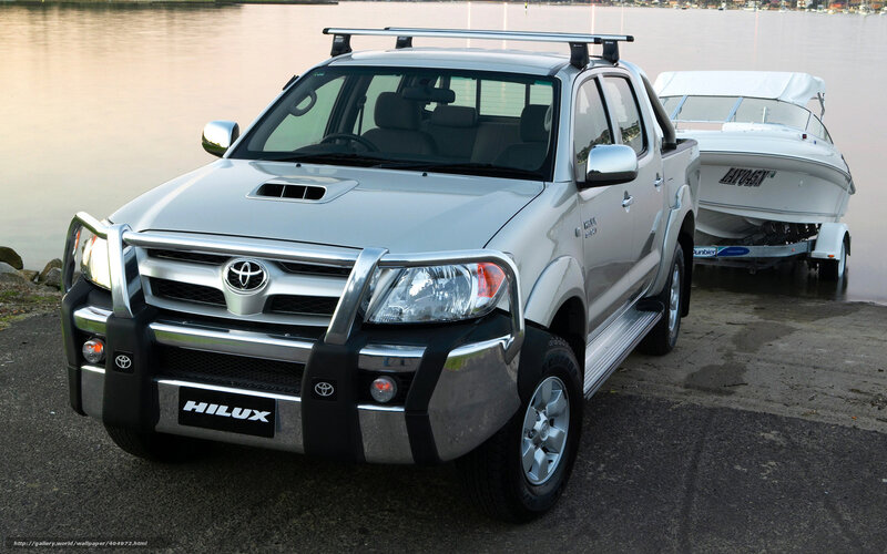 Silver Toyota Hilux towing boat