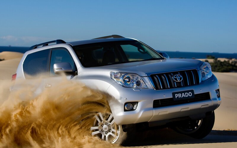 Silver Toyota Prado on sand dunes