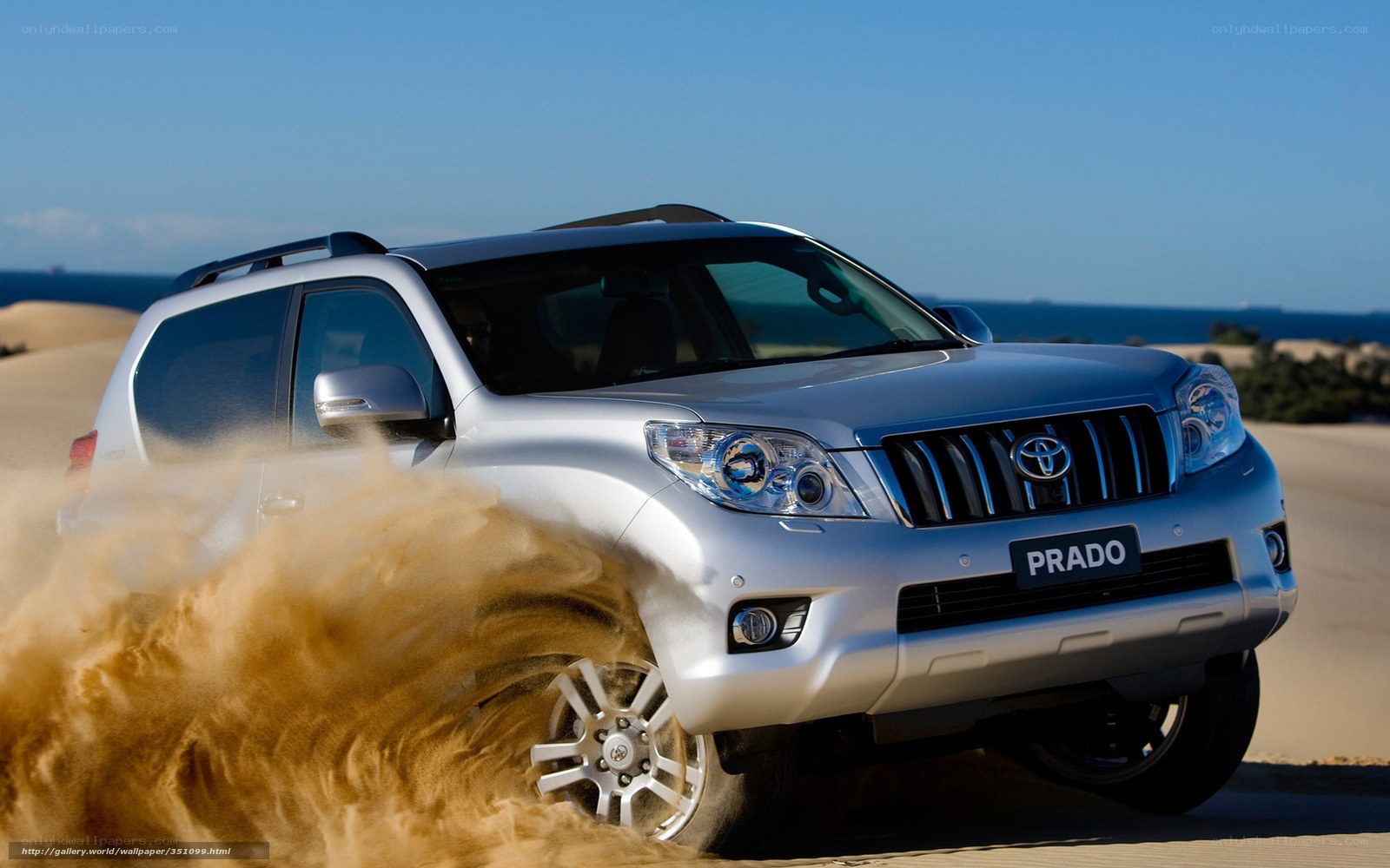 Silver Toyota Prado on sand dunes
