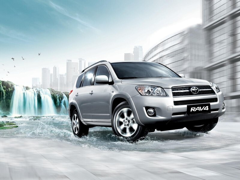 Silver Toyota RAV4 driving through water