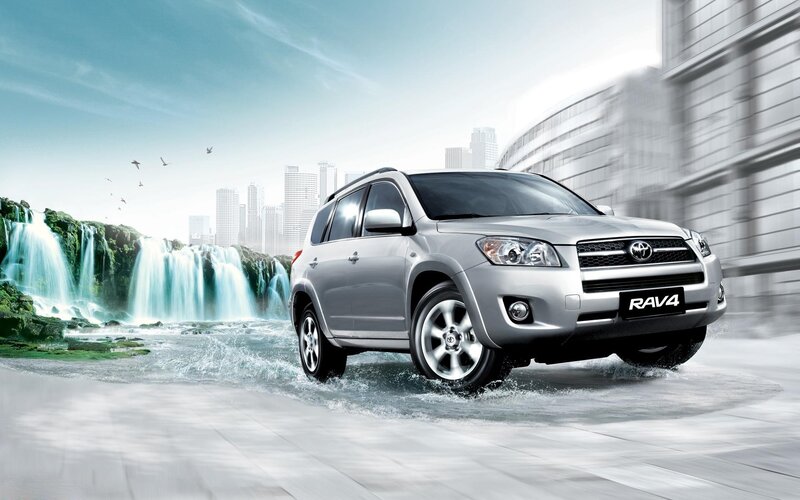 Silver Toyota RAV4 driving through water