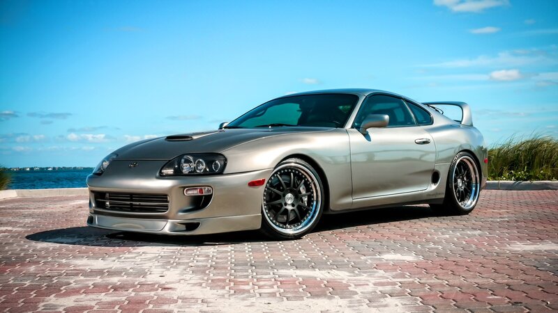 Silver Toyota Supra by the water
