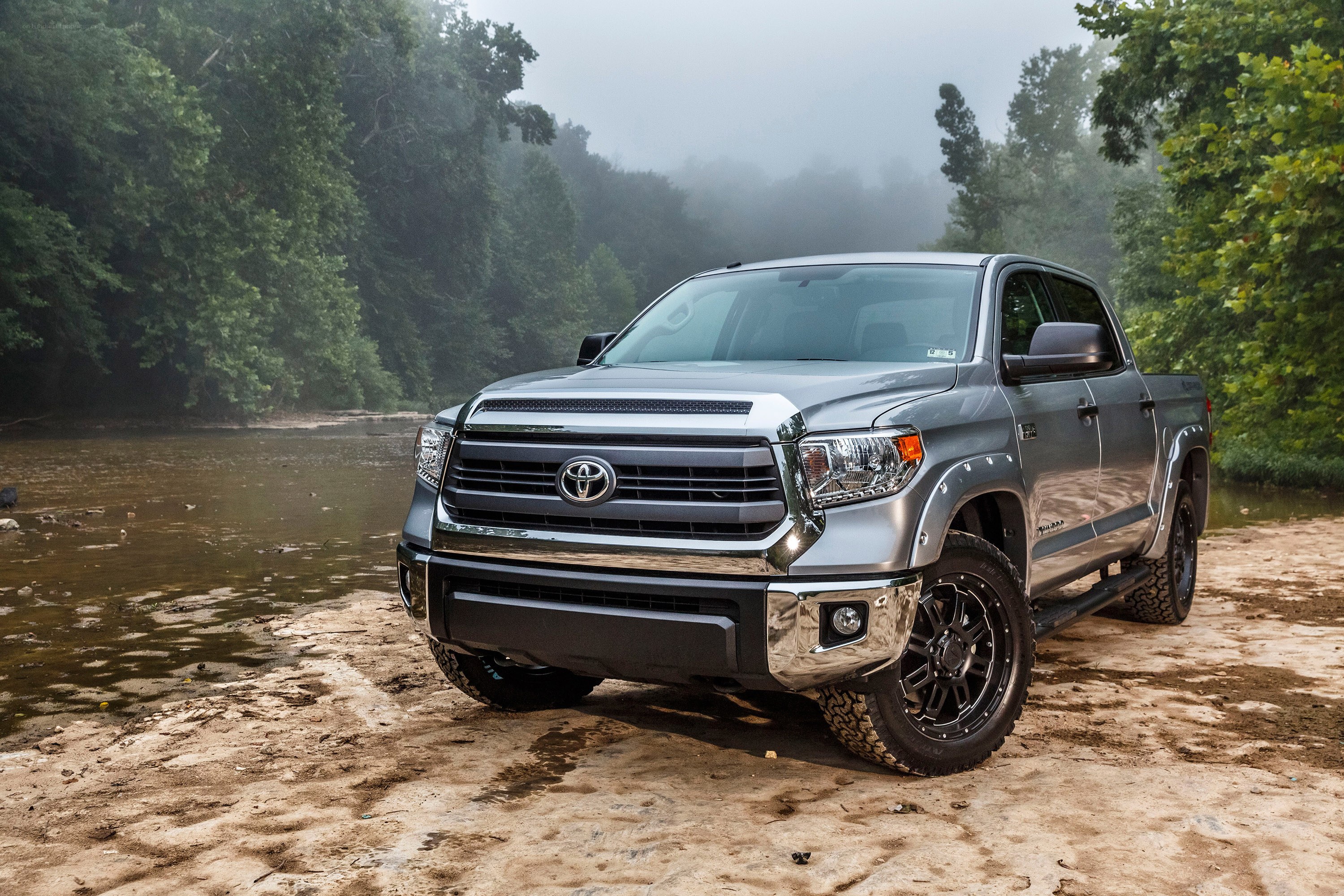 Silver Toyota Tundra by river