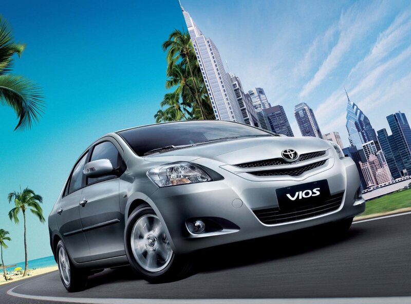 Silver Toyota Vios on a coastal road