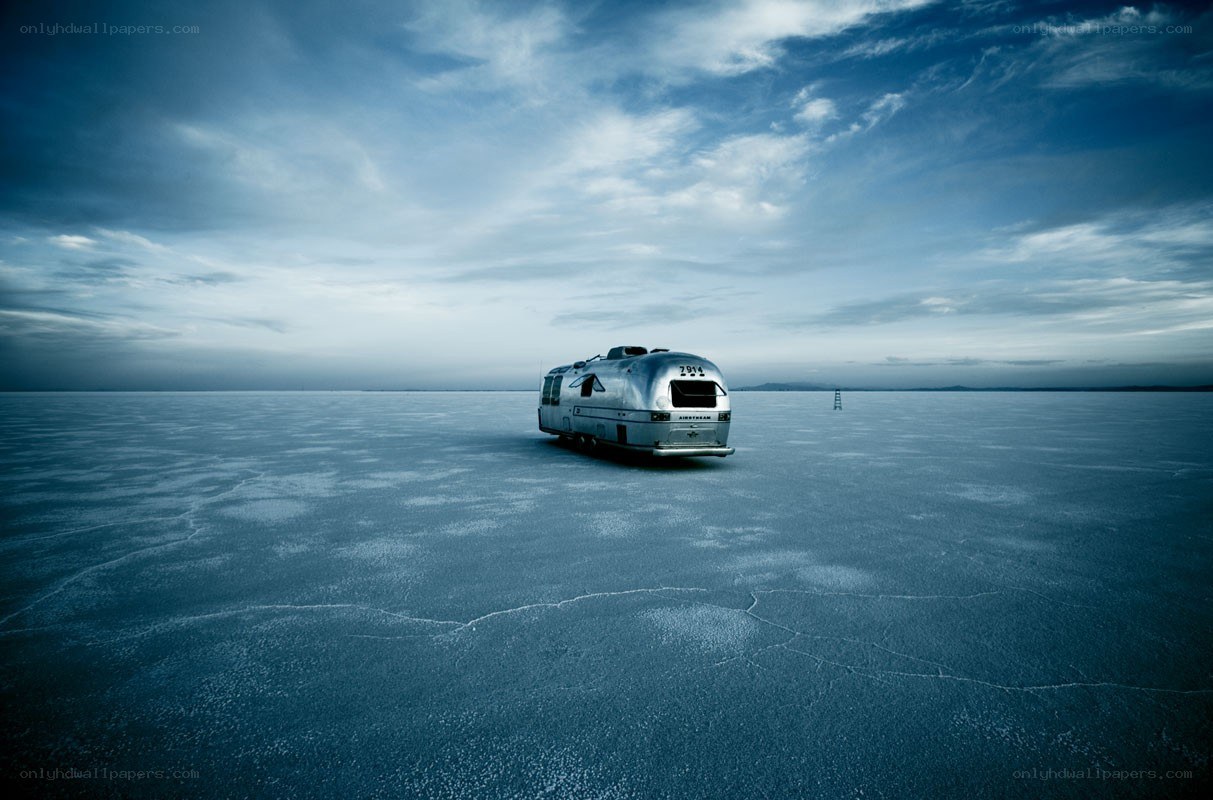 Silver trailer on a vast salt flat