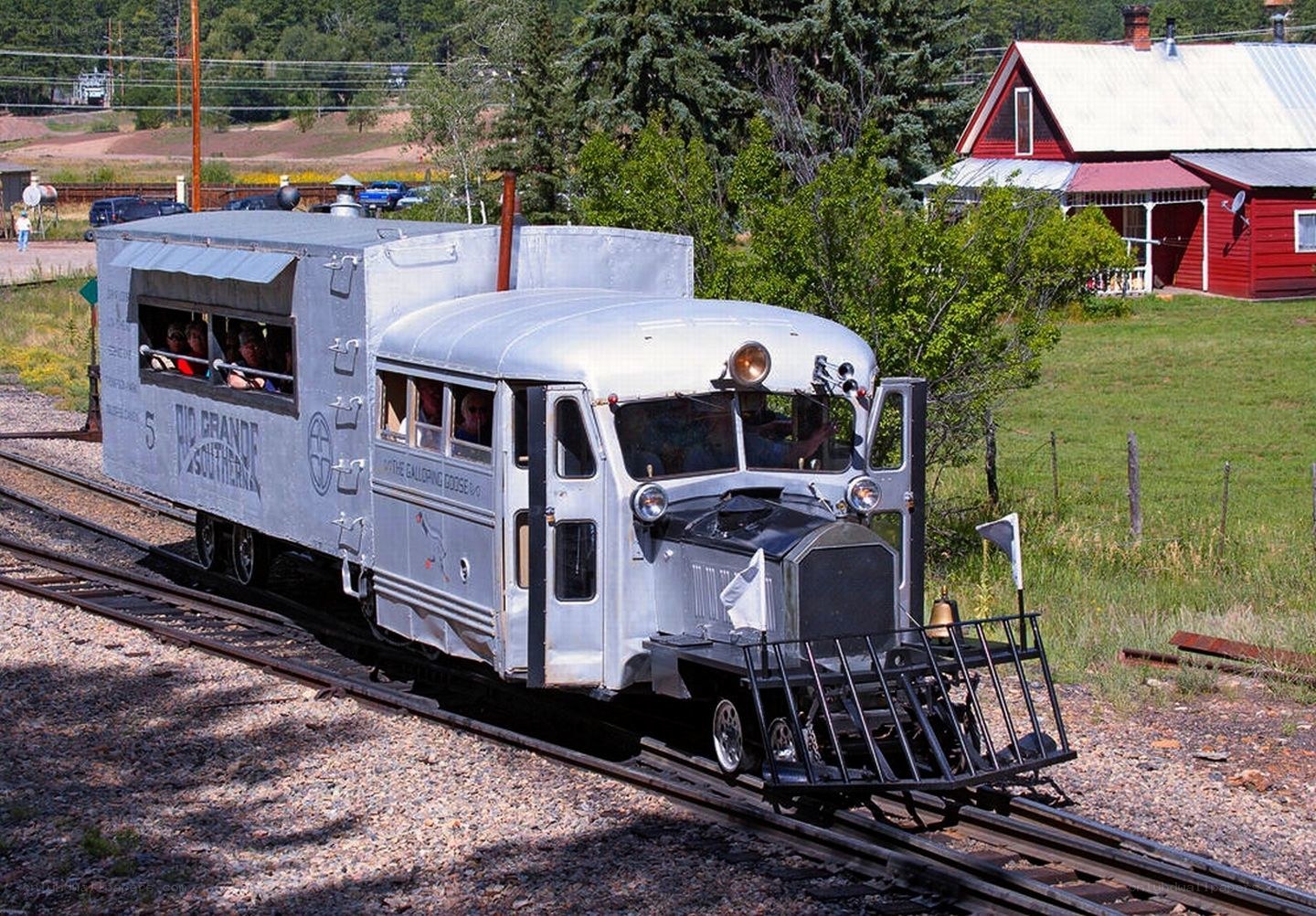 Silver train on narrow-gauge tracks