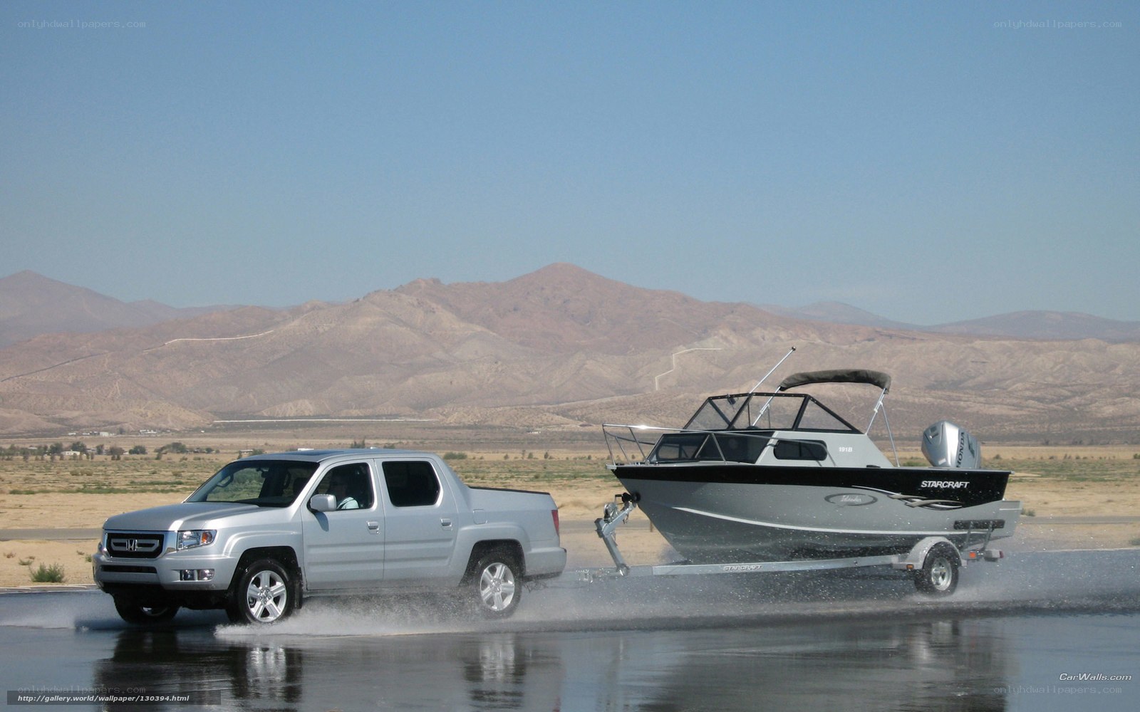 Silver truck towing boat