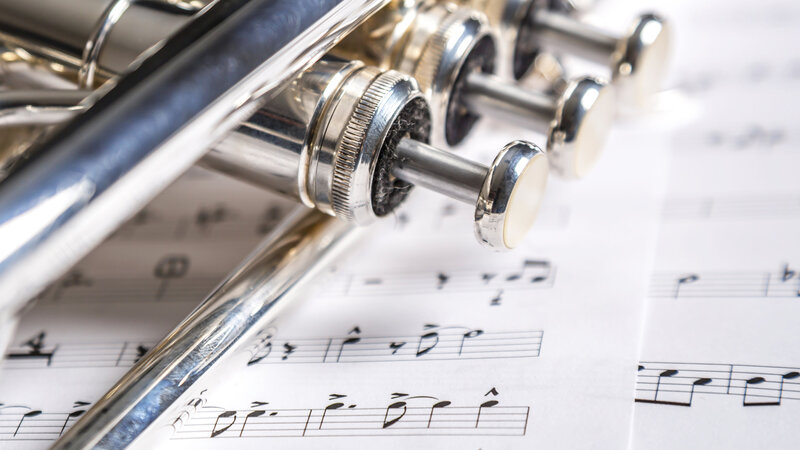 Silver Trumpet on Sheet Music — White