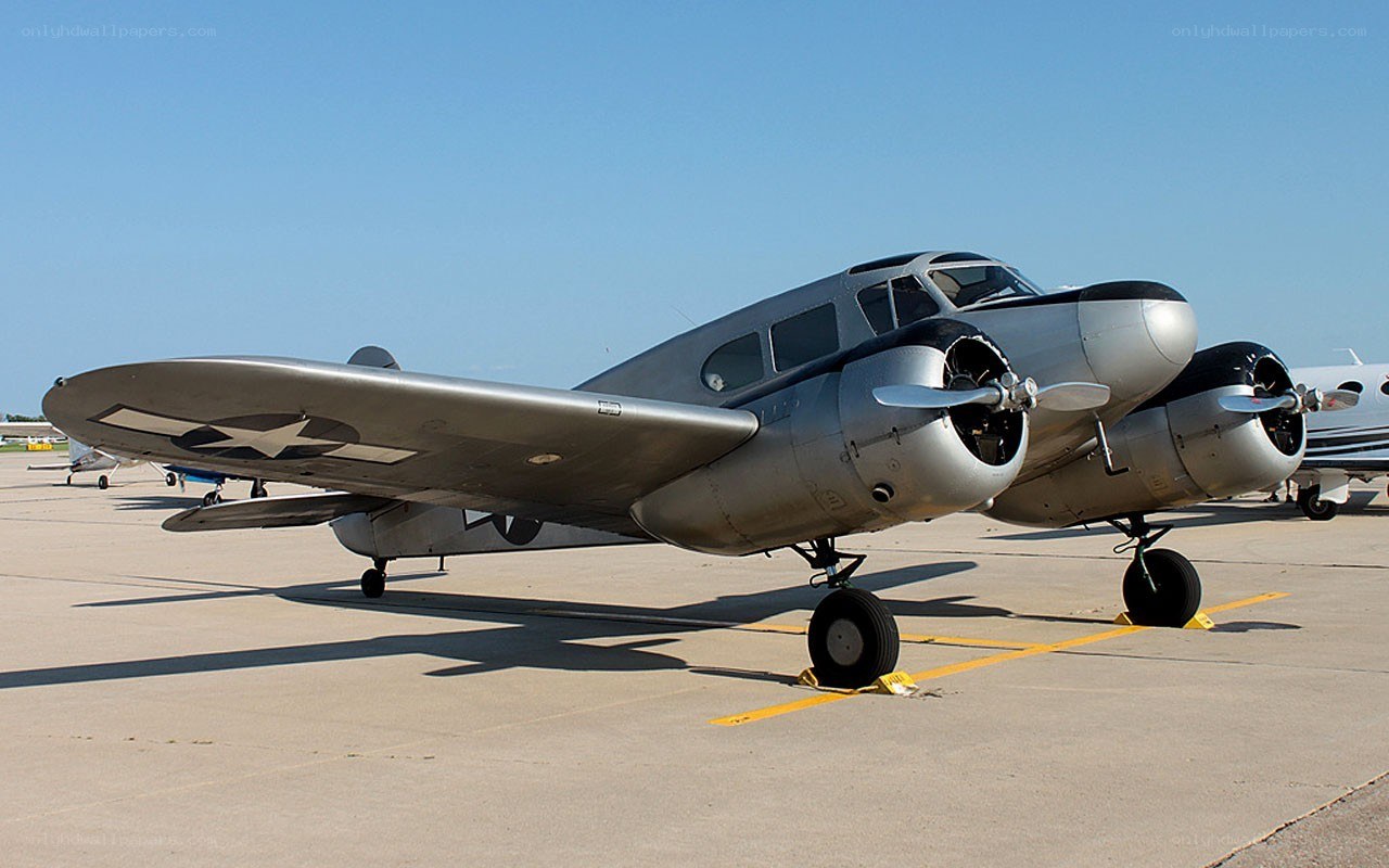 Silver twin-engine aircraft on tarmac