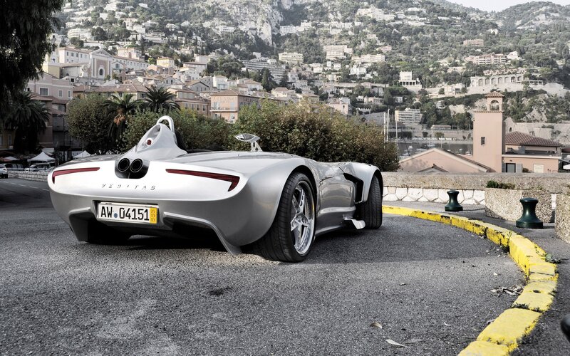 Silver Veritas sports car on a coastal road