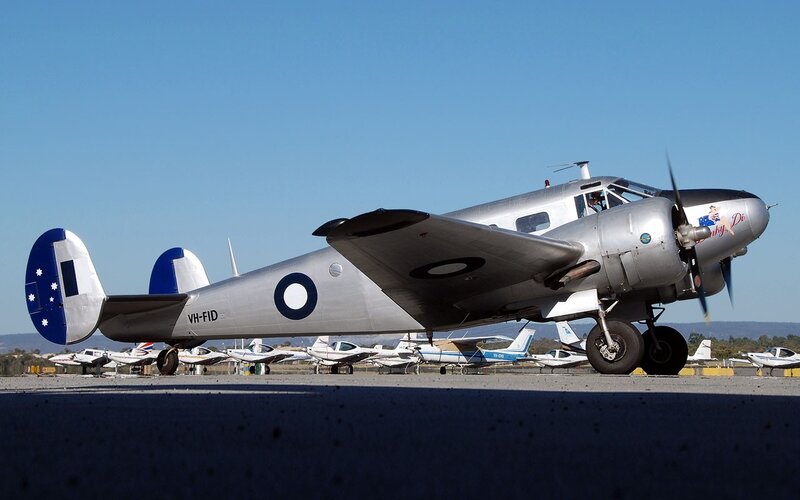 Silver vintage aircraft on tarmac