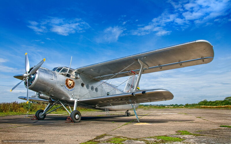 Silver vintage airplane on tarmac
