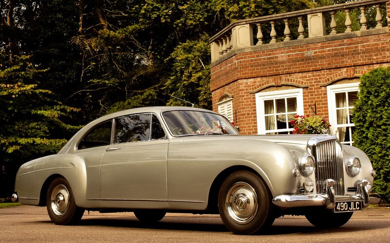 Silver Vintage Car — Serene, Afternoon, Photograph, Brick Building