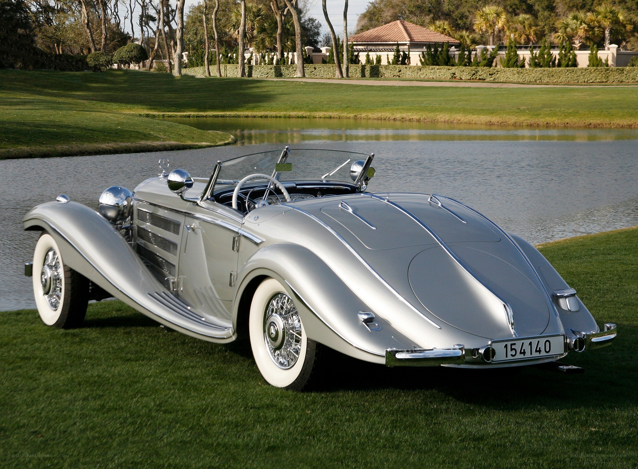 Silver vintage convertible by lake