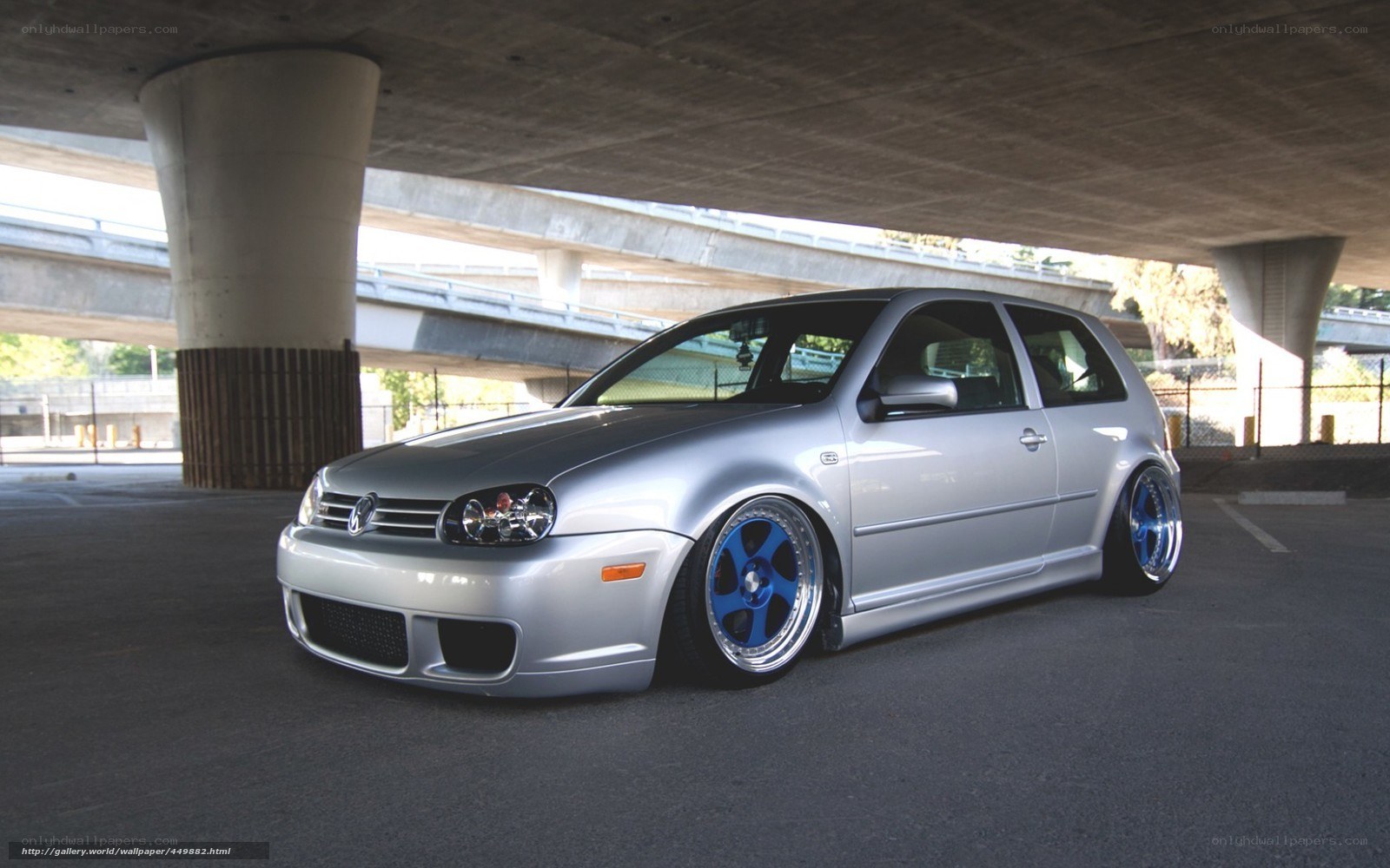 silver volkswagen golf under bridge