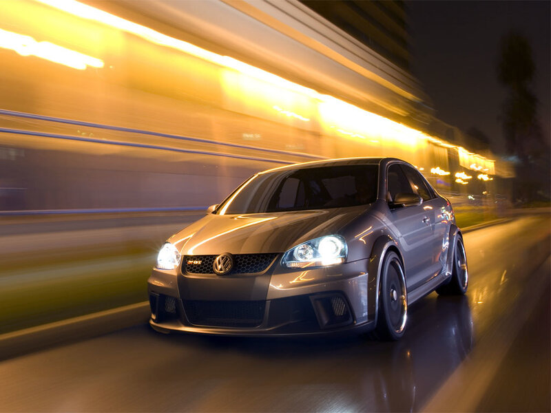 silver volkswagen jetta driving at night