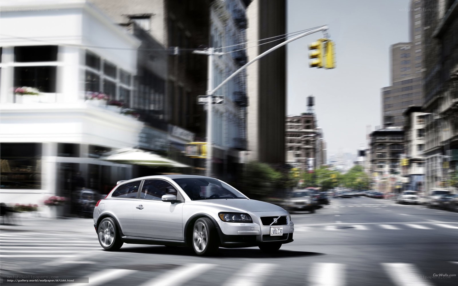 Silver Volvo C30 in city traffic