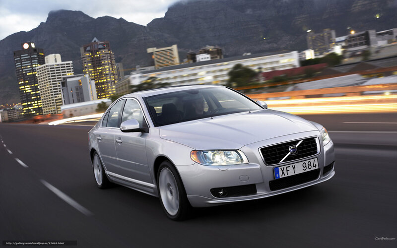 silver volvo driving in city