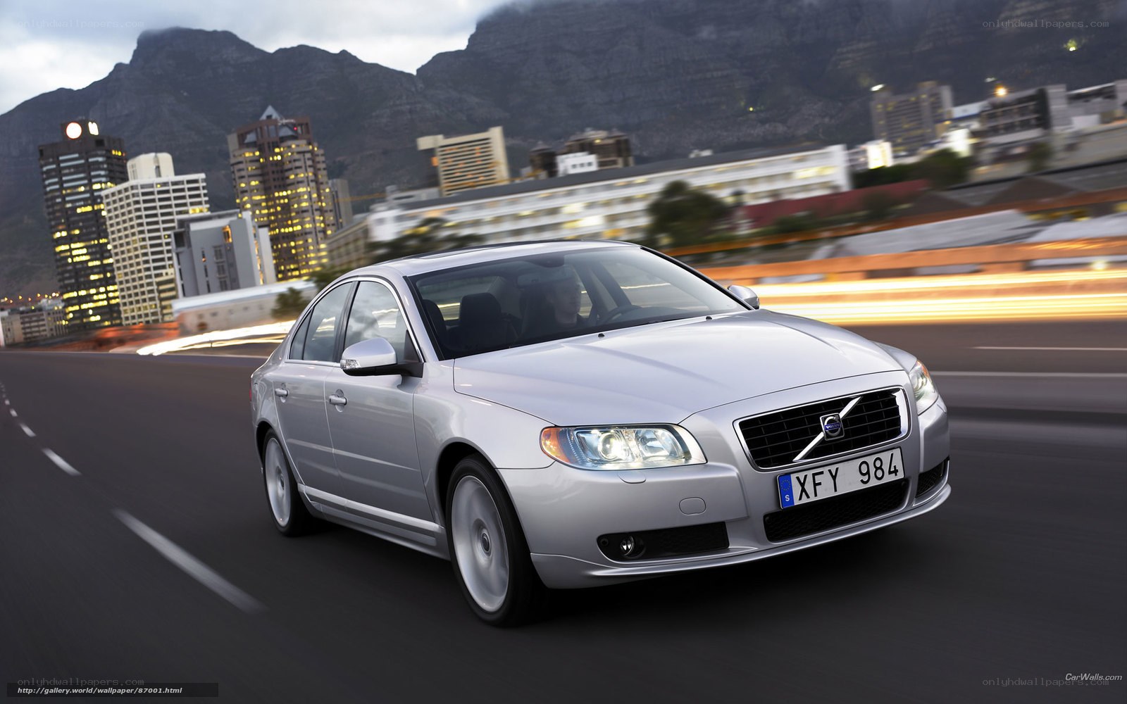 silver volvo driving in city