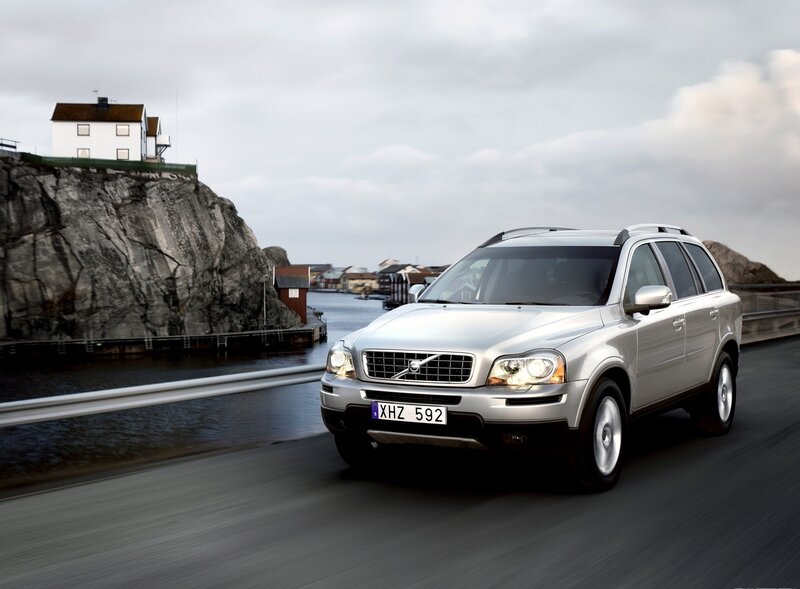 Silver Volvo driving on a coastal road