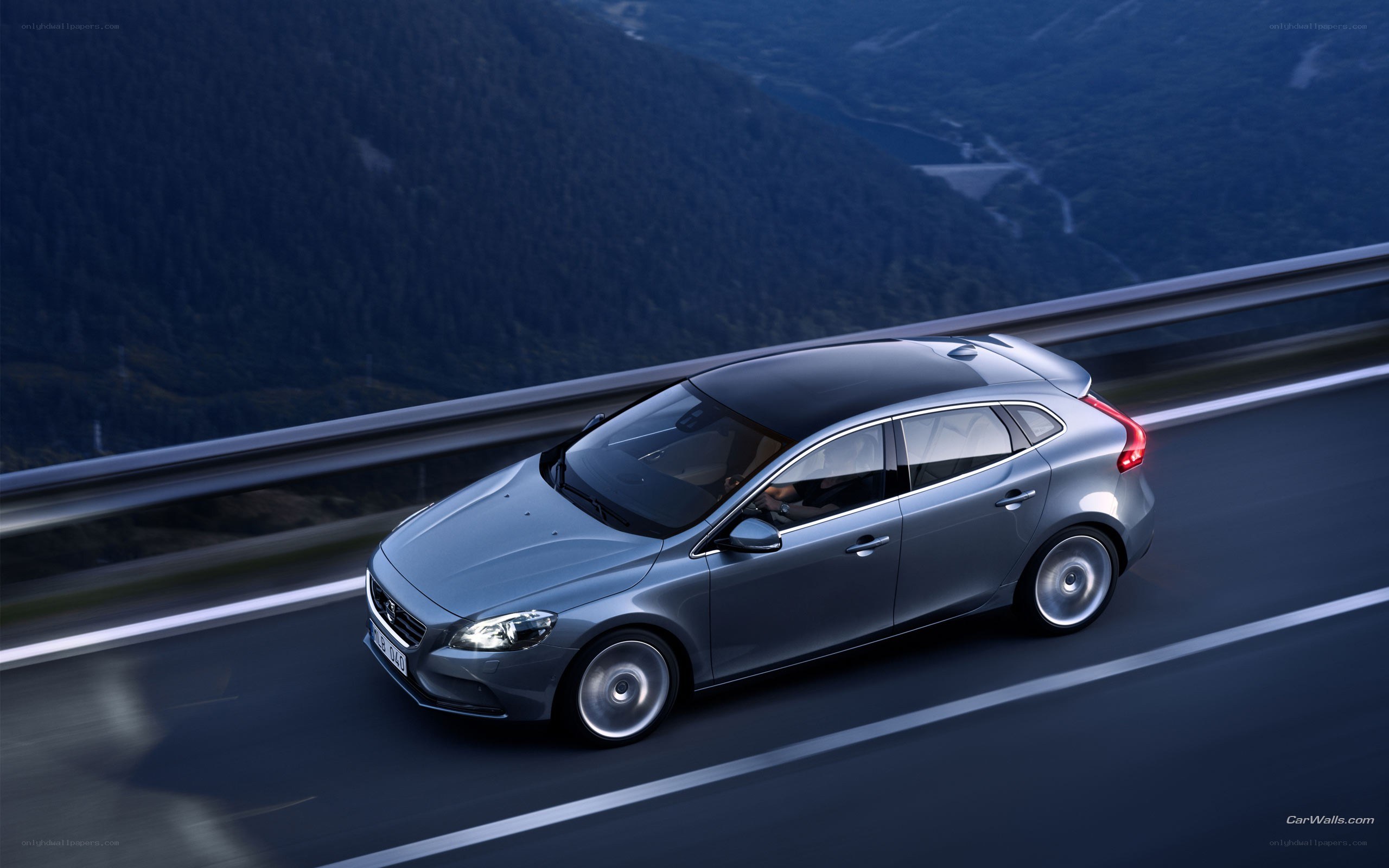silver volvo on mountain road