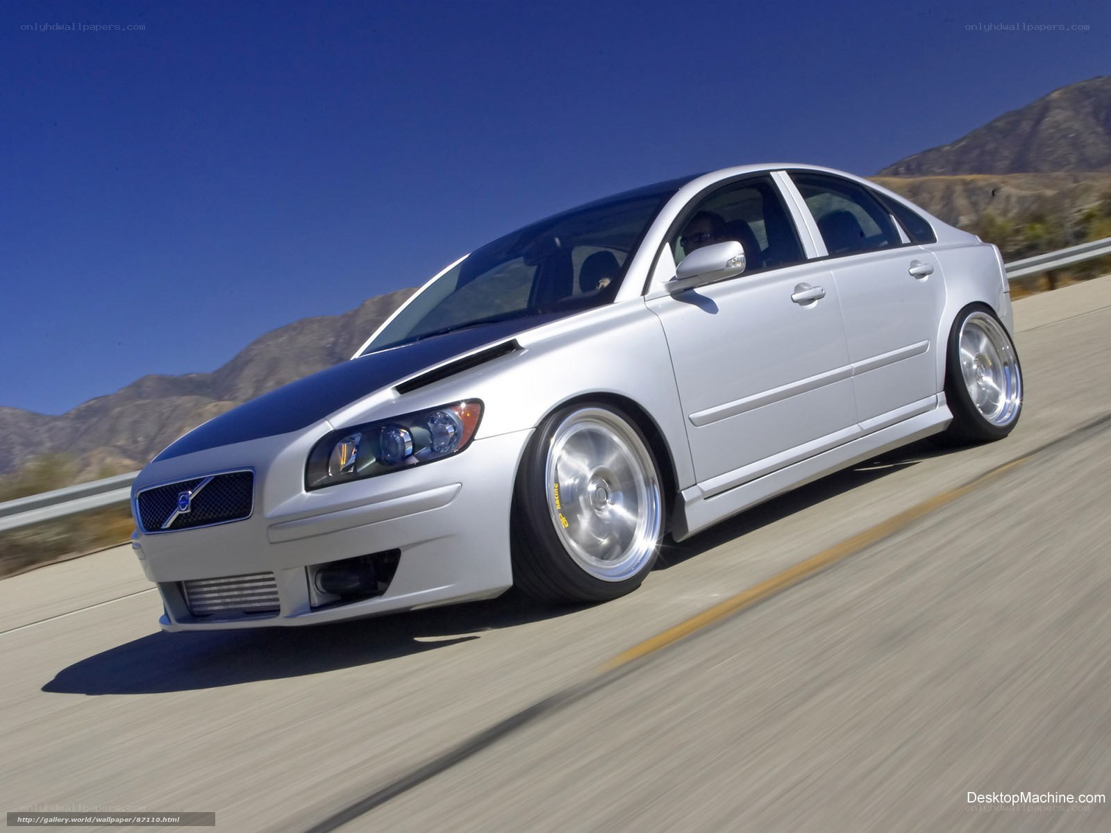 silver volvo on mountain road