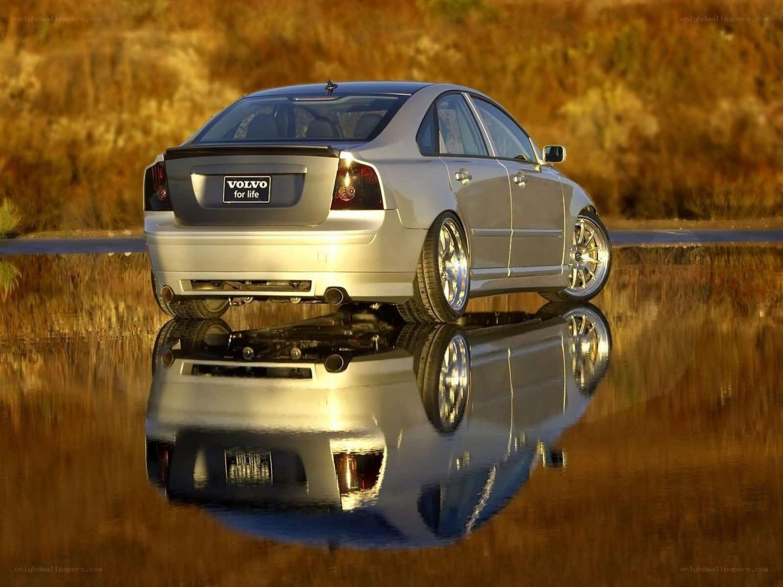 Silver Volvo on reflective water