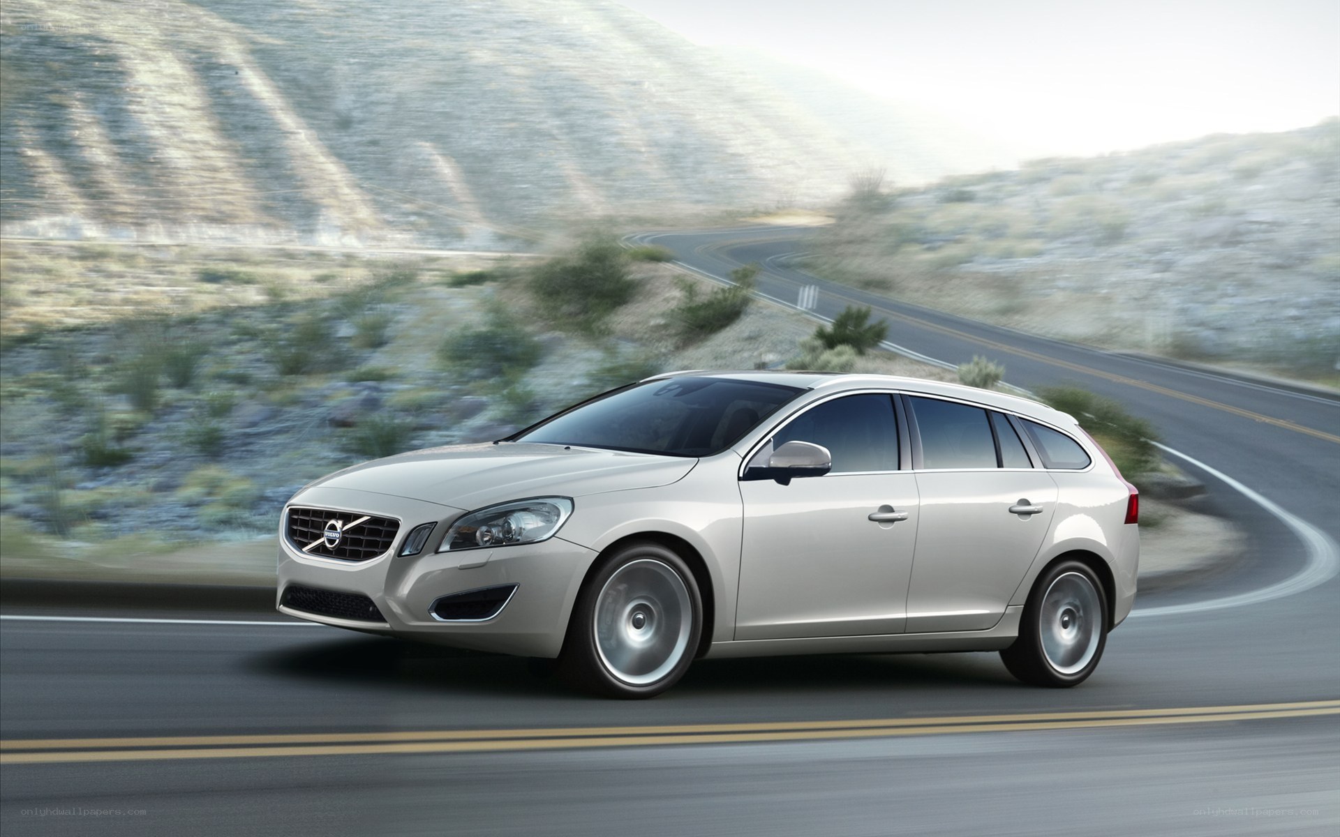 silver volvo on winding road