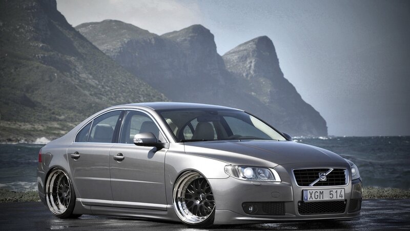 silver volvo sedan by the coast